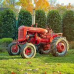 vintage red farmall tractor in autumn garden
